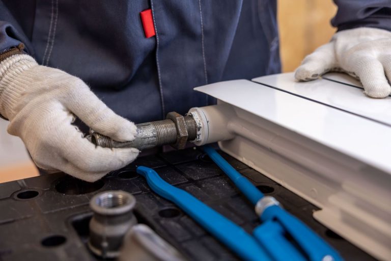Crafting Captivating Headlines: Your awesome post title goes here Close-up of a plumber installing a radiator pipe using specialized tools.